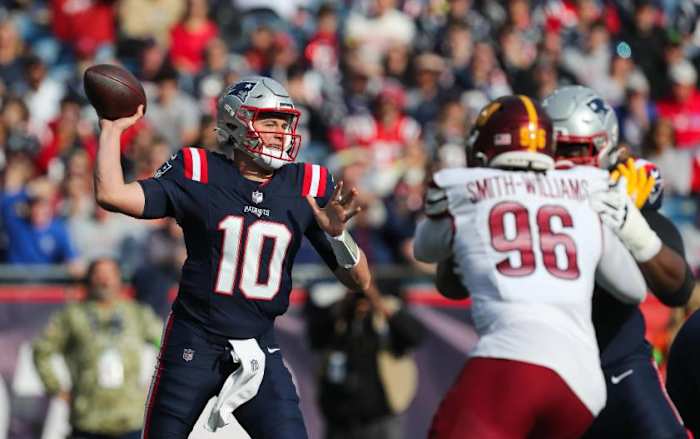 New England Patriots quarterback Mac Jones (10) passes the ball during the first half against the Washington Commanders at Gillette Stadium.